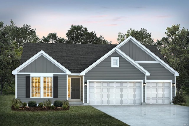 view of front of home featuring a lawn and a garage