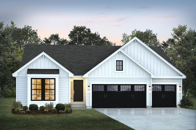 modern inspired farmhouse featuring a lawn and a garage