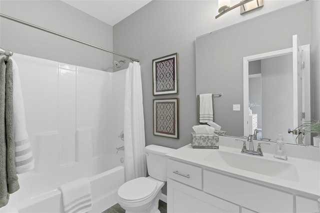 full bathroom featuring toilet, shower / tub combo with curtain, and vanity with extensive cabinet space