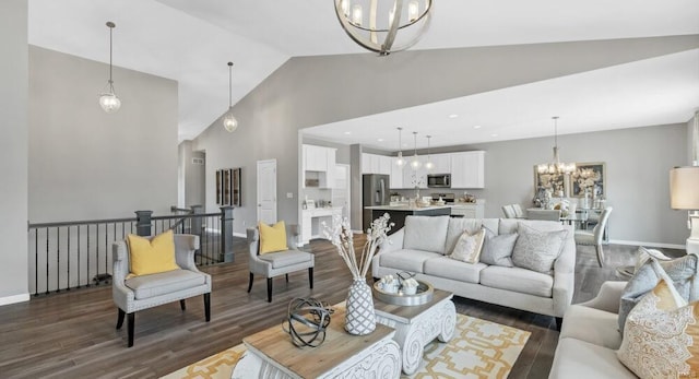 living room with high vaulted ceiling, an inviting chandelier, and dark wood-type flooring