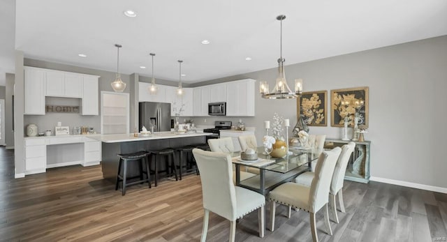 dining room with dark hardwood / wood-style floors and a chandelier