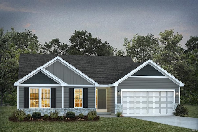 view of front of home with a lawn and a garage