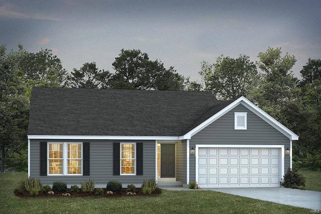 view of front of home with a yard and a garage