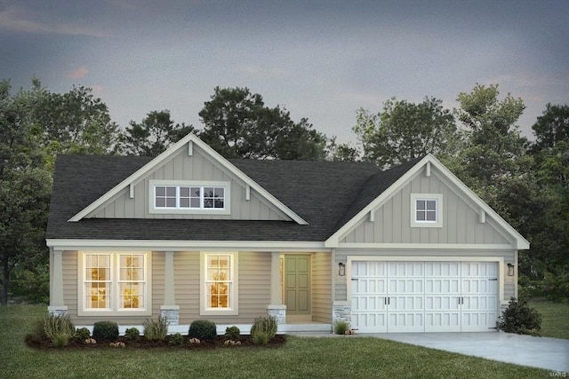 view of front facade with a porch, a garage, and a lawn