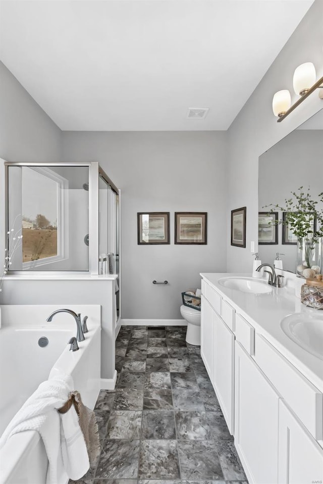 full bathroom featuring tile floors, dual sinks, toilet, separate shower and tub, and large vanity