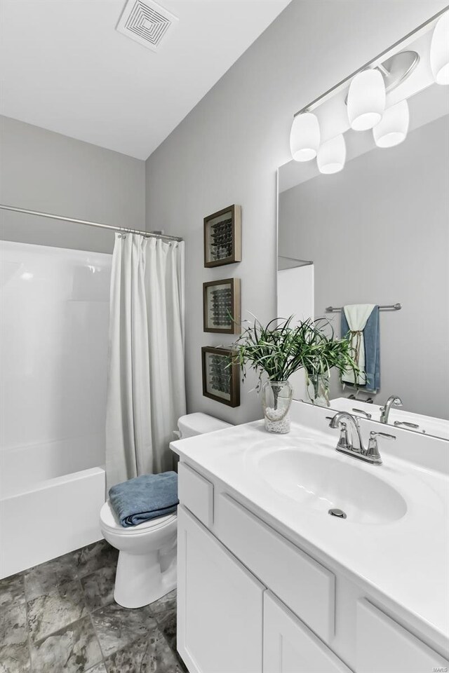 full bathroom with shower / tub combo, vanity, tile floors, and toilet