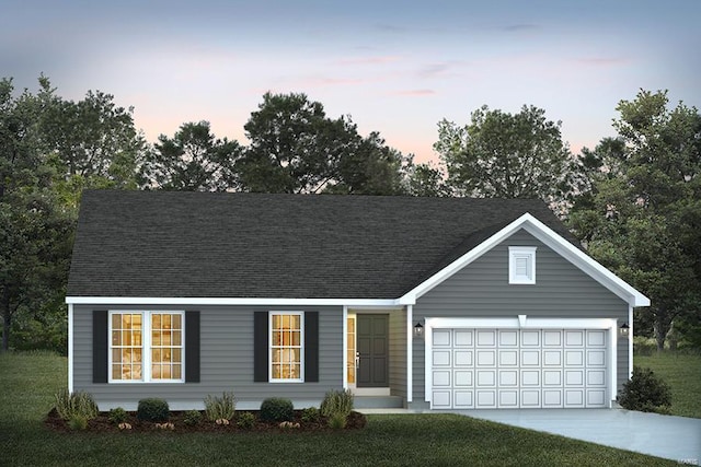 view of front facade featuring a lawn and a garage