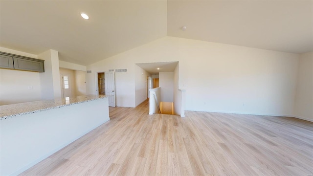 unfurnished living room featuring light hardwood / wood-style flooring and vaulted ceiling