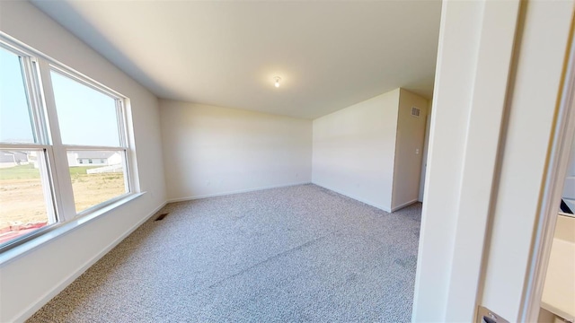 empty room featuring light carpet