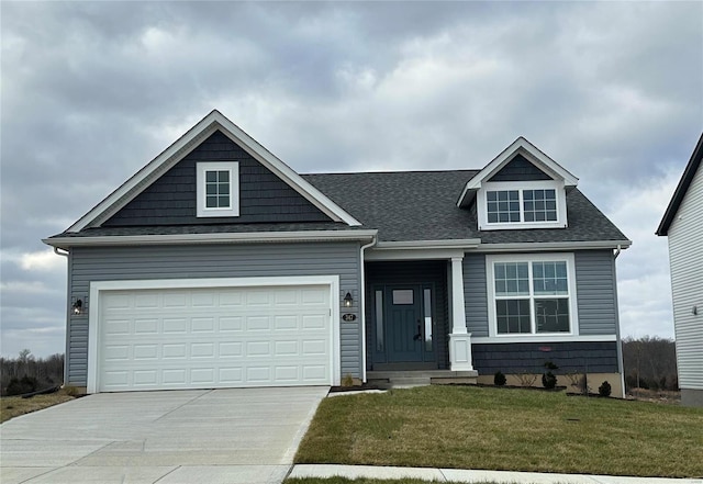 view of front of home with a garage and a front yard