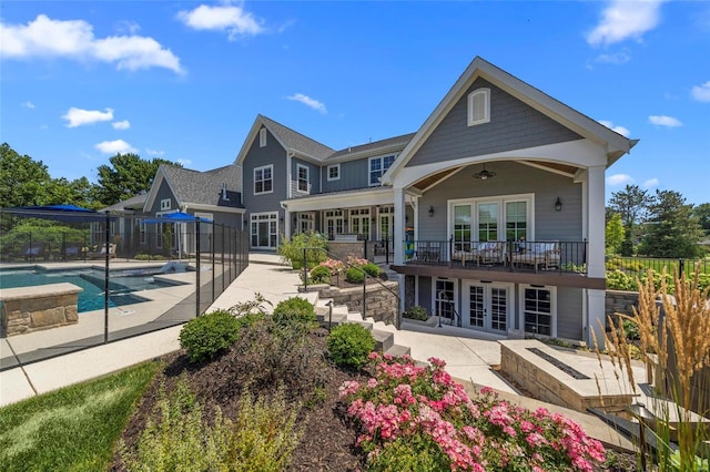 back of house featuring a patio, french doors, ceiling fan, and a fenced in pool