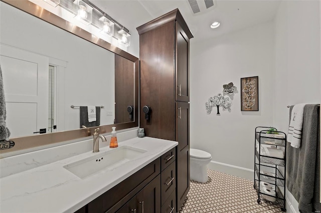 bathroom featuring large vanity, tile floors, and toilet