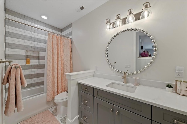 full bathroom featuring vanity, shower / bath combo with shower curtain, and toilet