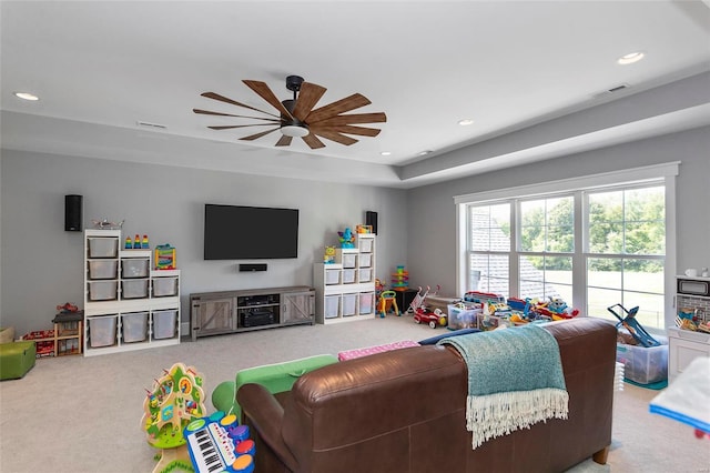 carpeted living room featuring ceiling fan