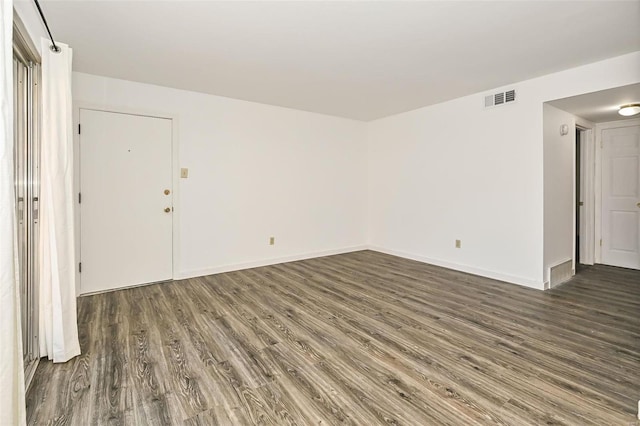 spare room featuring dark wood-type flooring