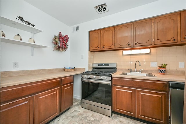 kitchen with appliances with stainless steel finishes, sink, backsplash, and light tile patterned floors