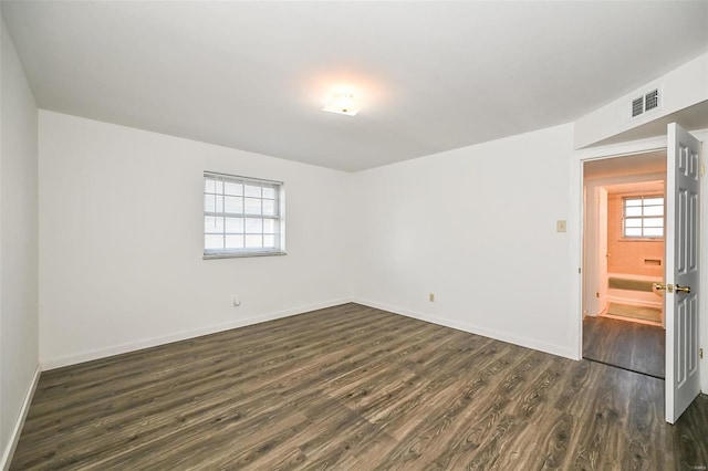 empty room with dark hardwood / wood-style flooring