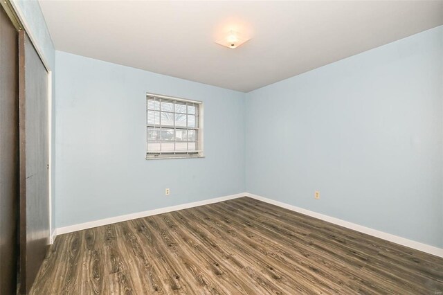 spare room with dark hardwood / wood-style floors