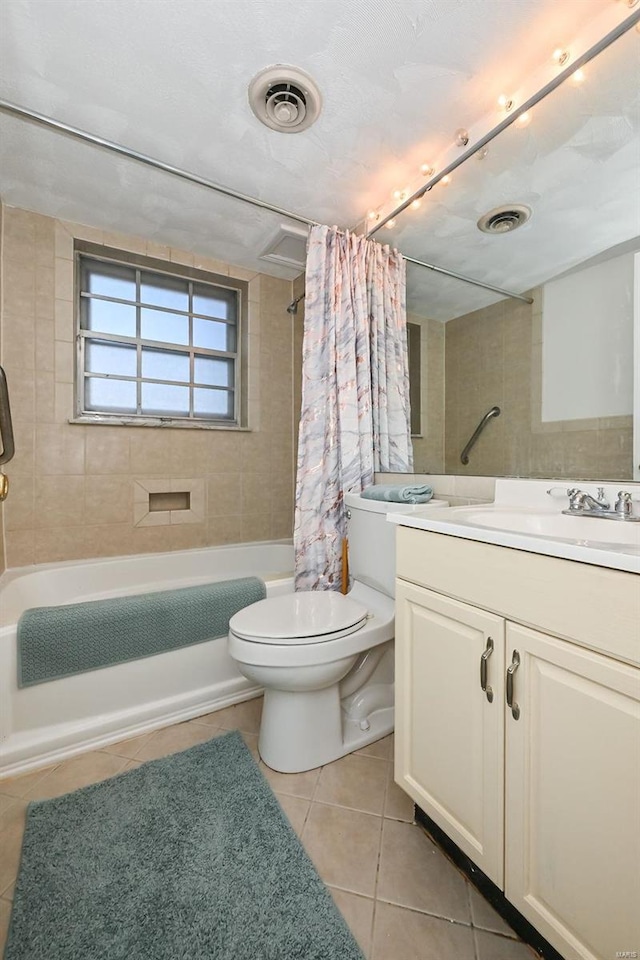 full bathroom featuring shower / bath combo with shower curtain, vanity, tile patterned flooring, and toilet