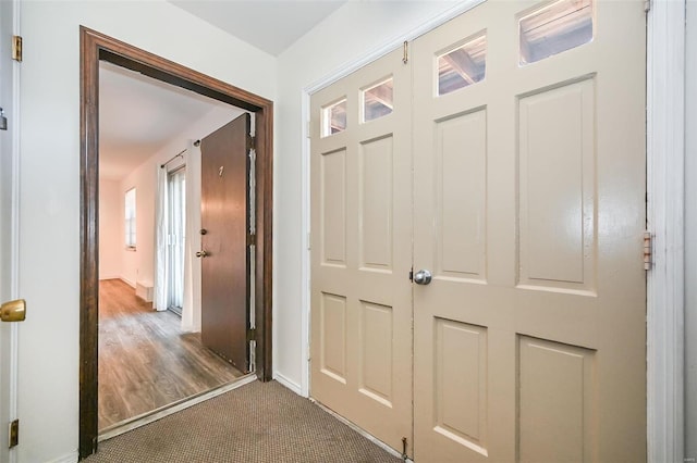 corridor with dark colored carpet