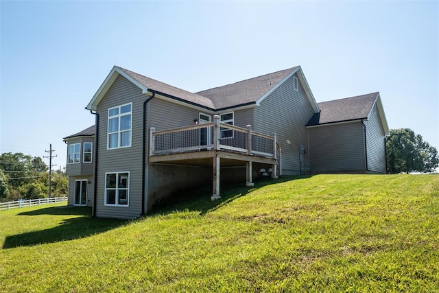 view of side of property with a wooden deck and a yard