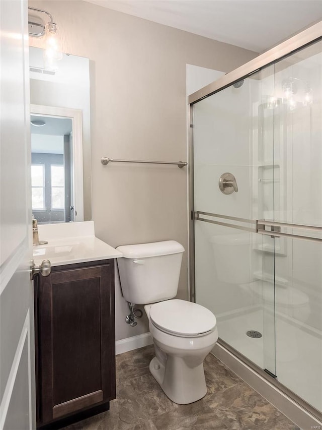 bathroom featuring tile floors, toilet, walk in shower, and vanity