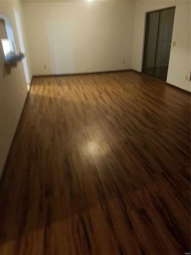 unfurnished bedroom with dark hardwood / wood-style floors