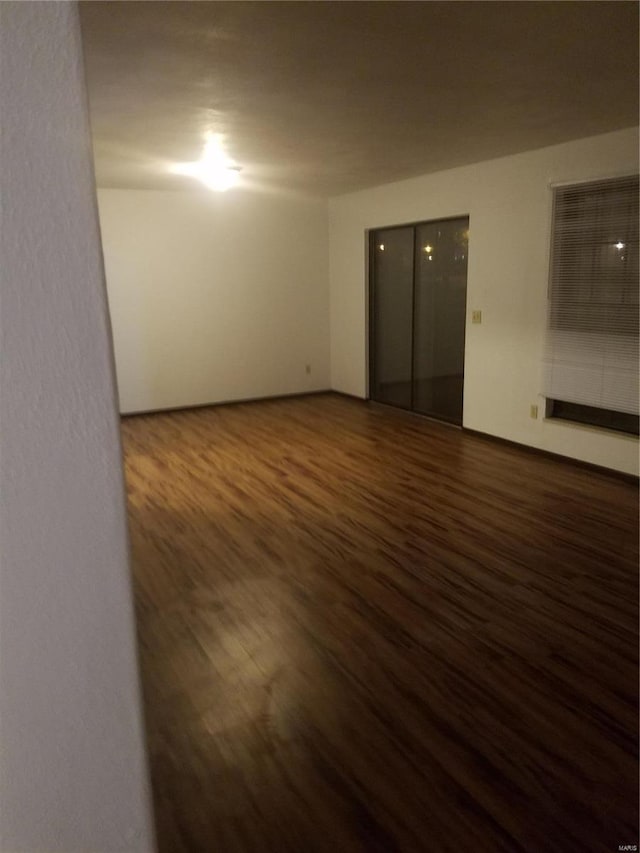 empty room featuring dark hardwood / wood-style flooring