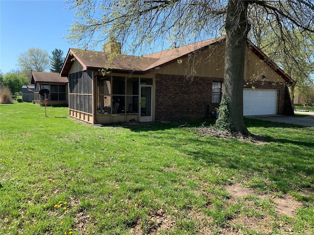 view of front of home featuring a front yard, a garage, and a sunroom