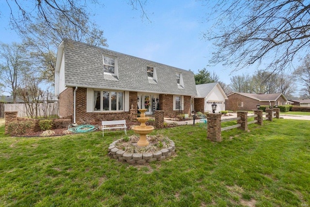 rear view of property with a yard and a garage