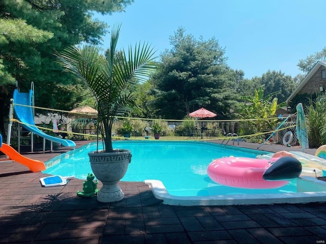 view of pool with a water slide