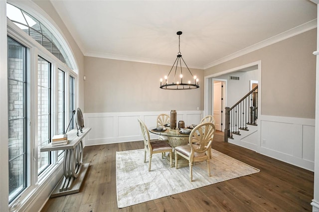 dining room featuring ornamental molding, a notable chandelier, and wood-type flooring