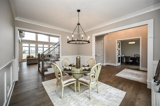 dining room with an inviting chandelier, ornamental molding, and dark hardwood / wood-style flooring