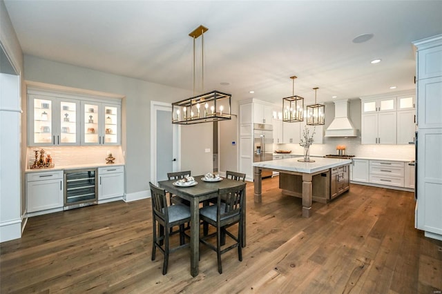 dining space with beverage cooler and dark wood-type flooring