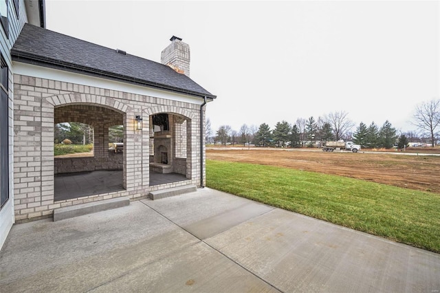 view of patio with an outdoor fireplace