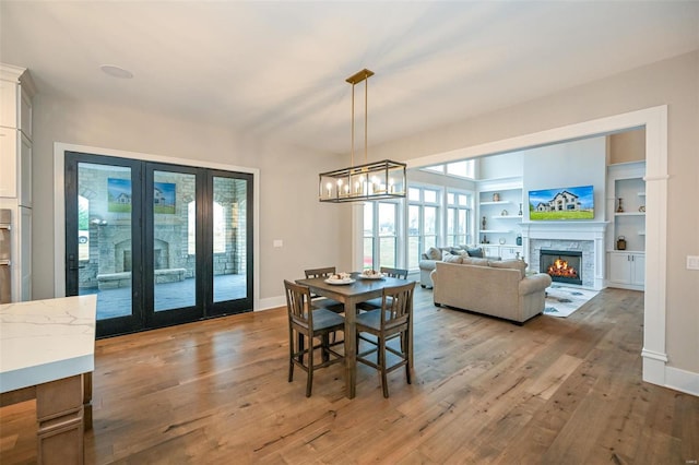 dining area with light hardwood / wood-style flooring and a chandelier