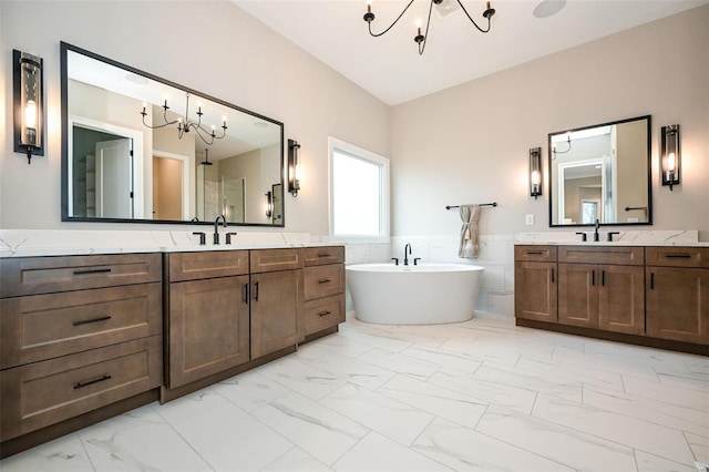 bathroom featuring vanity, tile walls, a tub to relax in, and a chandelier