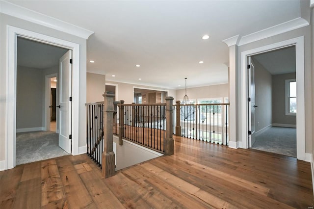 hall featuring crown molding, a chandelier, and hardwood / wood-style floors