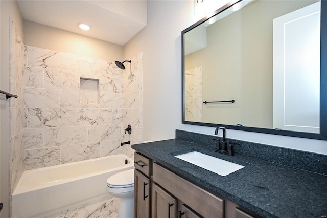 full bathroom featuring toilet, vanity, and tiled shower / bath