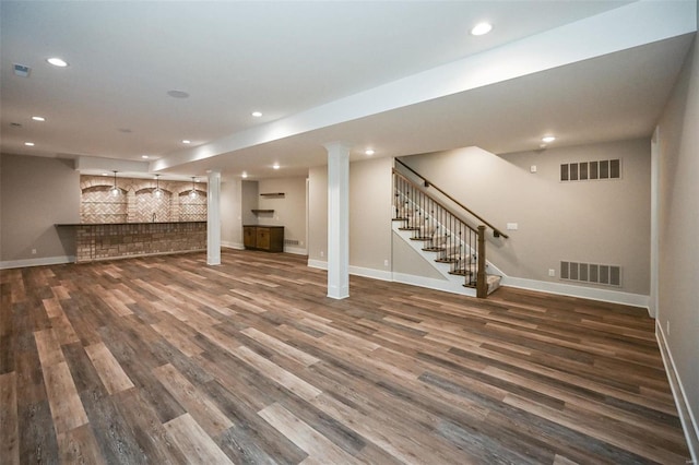 finished below grade area featuring stairway, visible vents, and recessed lighting