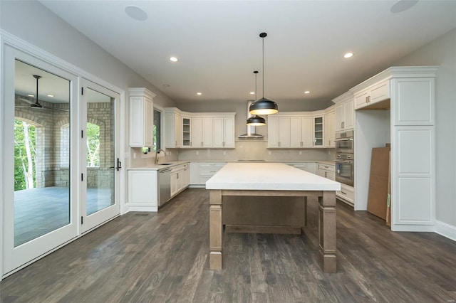 kitchen featuring dark wood-style floors, dishwasher, glass insert cabinets, and a sink