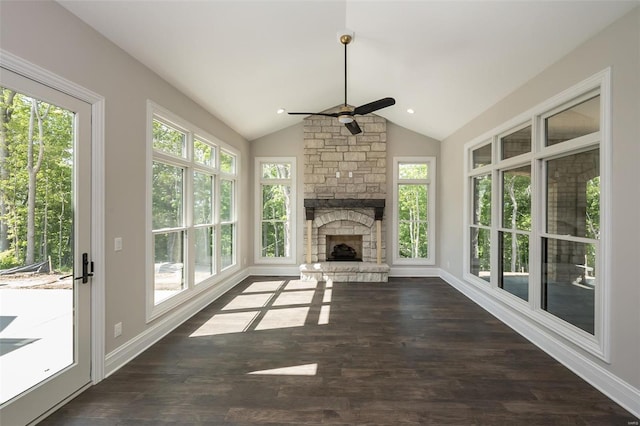 unfurnished living room with dark wood-style floors, baseboards, lofted ceiling, a fireplace, and ceiling fan