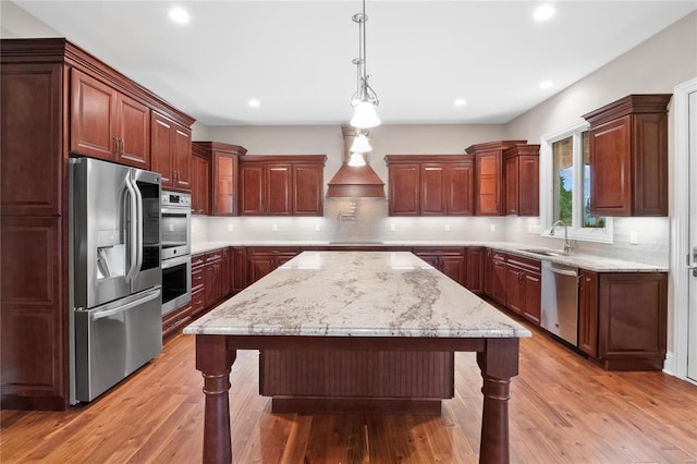 kitchen featuring a kitchen island, a breakfast bar area, light hardwood / wood-style floors, stainless steel appliances, and tasteful backsplash