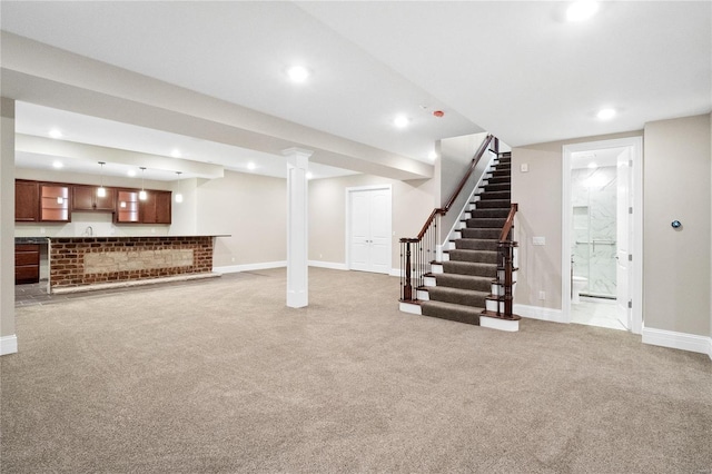 basement featuring sink and light colored carpet