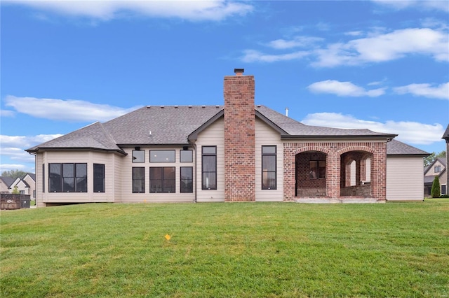 rear view of property with a lawn