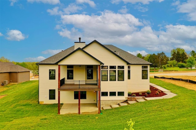 back of house with a yard and a patio area