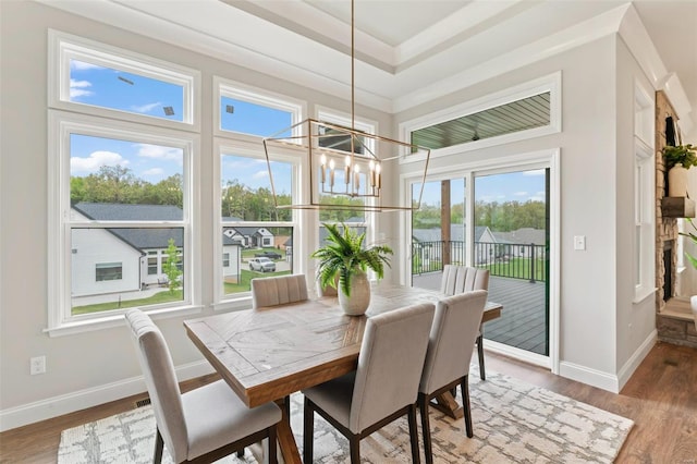 dining area with hardwood / wood-style flooring and a chandelier