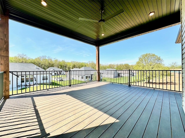 deck featuring a yard and ceiling fan