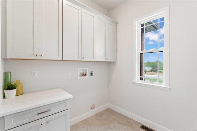 laundry room with cabinets, hookup for a washing machine, and hookup for an electric dryer