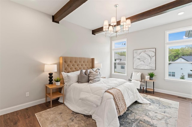 bedroom featuring dark wood-type flooring, a chandelier, and beamed ceiling